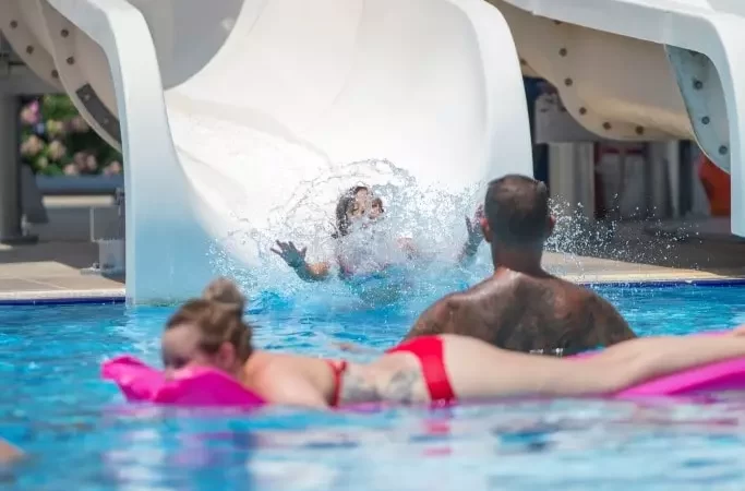 a woman is swimming in the pool