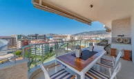 down-floor balcony with table and chairs