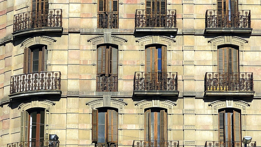 Corner apartment building with balconies in Barcelona, Spain