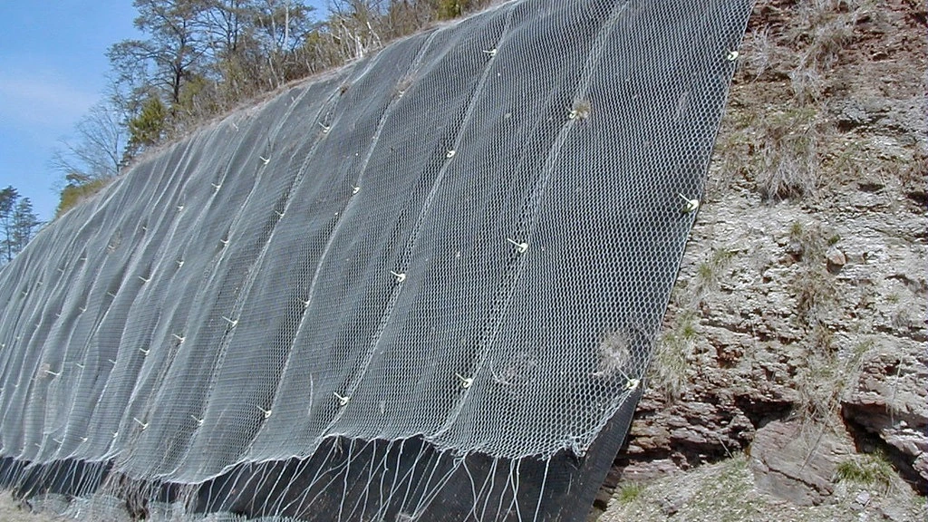 Wire mesh slope-stabilisation measures beside a road cutting