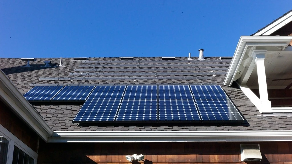 Solar photovoltaic panels installed on the pitched roof of a house