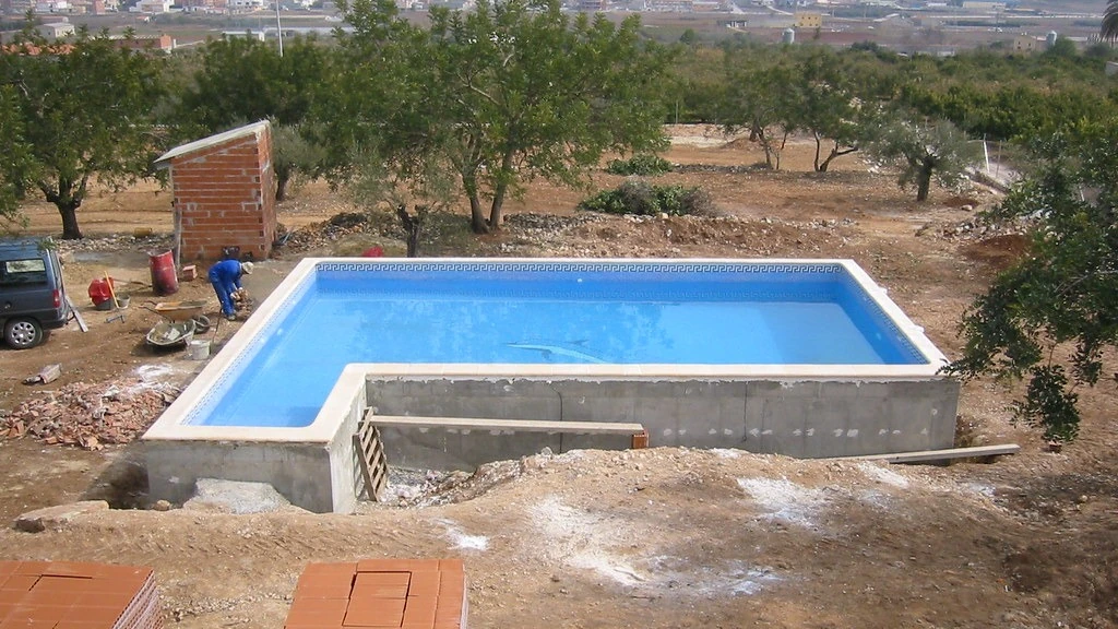 Residential swimming pool structure under construction before finishing